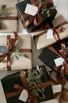 several wrapped presents with ribbons and tags on them