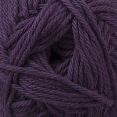 a ball of purple yarn on a white surface