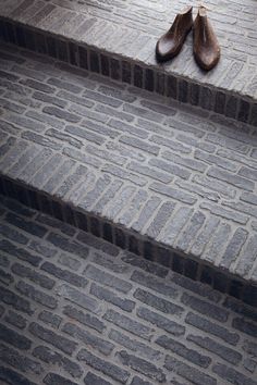 two pairs of shoes sitting on the steps