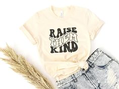 Add a unique touch to any mom's wardrobe with this retro-style "Raise them Kind" shirt. Featuring a bold and eye-catching message, this shirt serves as a reminder of the importance of kindness and compassion in raising children. The relaxed fit and high-quality materials make it comfortable for everyday wear. Available in different colors and sizes, this shirt is a great gift for any mom who values raising kind and compassionate children. Creative Mother's Day Gifts, Kindness And Compassion, Mom Wardrobe, Mothers Day Shirts, Shirt Collection, Style Board, Mens Fitness