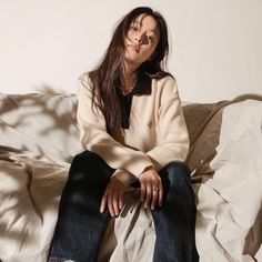 a woman sitting on top of a white couch