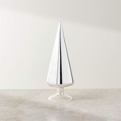 a white vase sitting on top of a table