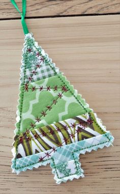 a christmas tree ornament hanging on a wooden table