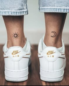 a woman's foot with a tattoo on her left ankle and the word air written in gold ink