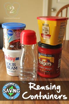 four containers of condiments sitting on top of a wooden table with the words reusing containers