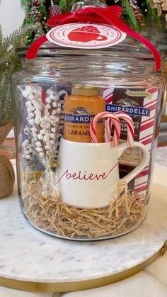 a glass jar filled with assorted items on top of a table