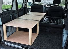 the back end of a van with a table in it