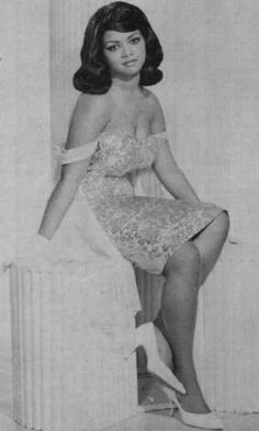 a black and white photo of a woman in a dress