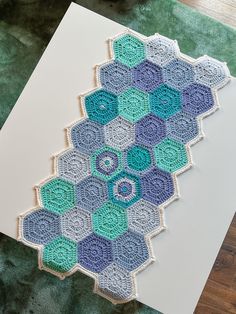 a card with crocheted hexagons on it sitting on top of a table