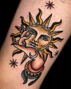 a sun and moon tattoo on the left leg, with stars around it's edges