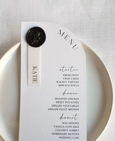 a white plate topped with a black and white menu