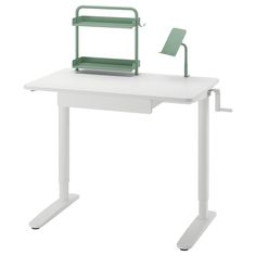 a white desk with a green chair sitting on it's top and the seat up