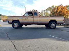 a tan pickup truck parked in a parking lot