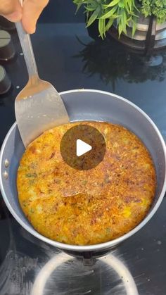 someone is using a spatula to stir up food in a pan