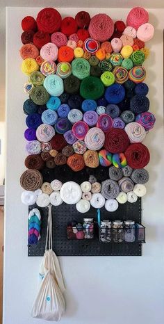 there is a wall hanging with yarn on it