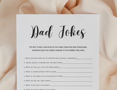 a card with the words dad jokes written in black ink on top of white fabric