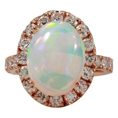 6.70 Carats Natural  Impressive Ethiopian Opal and Diamond 14K Solid Rose Gold Ring Suggested Replacement Value: $6,800.00 Total Natural Opal Weight is: Approx. 5.00 Carats  Total Natural Round Diamonds Weight: Approx. 1.70 Carats (color G-H / Clarity SI1-SI2) Ring total weight: 6.0 grams Disclaimer: all weights, measurements and colors are approximate and may vary slightly from the listed dimensions or as seen in the image. All pictures are magnified to show the smallest of details. Please, ref Luxury Rose Gold Opal Gemstone Ring, Formal Rose Gold Opal Ring With Diamond, Luxury Rose Gold Opal Ring, Formal Rose Gold Opal Ring, Ring Rosegold, Natural Opal, Opal Jewelry, Opal Rings, Cocktail Rings