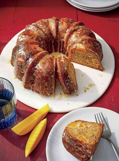 a bundt cake sitting on top of a white plate next to slices of lemon