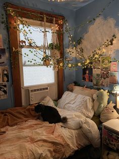 a cat laying on top of a bed in a room with blue walls and decorations