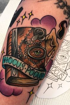 a close up of a person's arm with tattoos on it and an eye