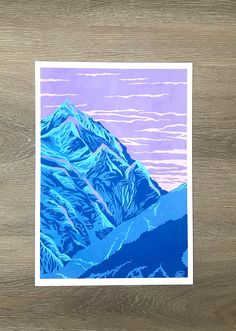 a painting of mountains on a wooden surface