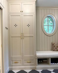 a room with white cabinets and black and white checkered floor