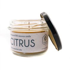 a jar of citrus candle with a lid on the front and inside it