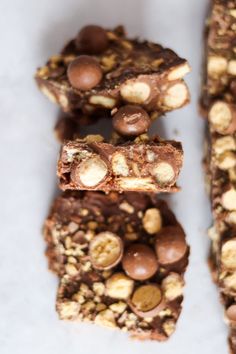 several pieces of chocolate and nuts are stacked on top of each other