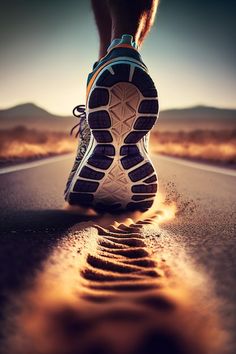 a person's feet walking down the middle of an empty road