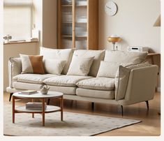 a living room filled with furniture and a clock on the wall