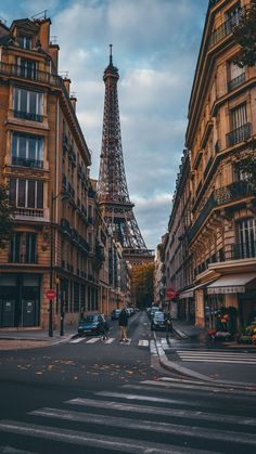 the eiffel tower towering over the city of paris, france as seen from an empty street