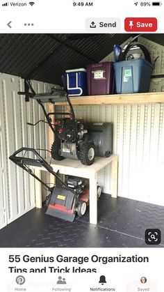 a small garage with two lawn mowers on the shelf