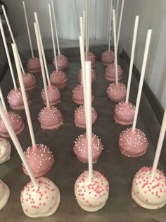 cake pops with white and pink sprinkles on them