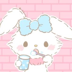 a drawing of a bunny holding a cup and drinking from a straw in front of a brick wall