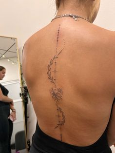 a woman with a tattoo on her back