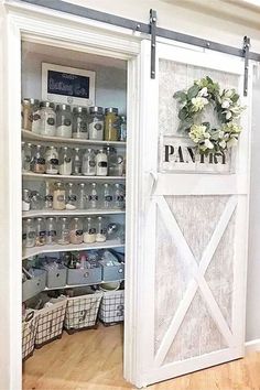 a pantry with white doors and shelves filled with items