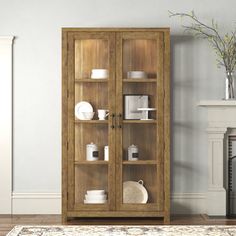 a wooden cabinet with glass doors in a living room