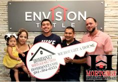 a group of people holding up signs in front of a sign that says envision tile