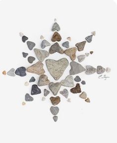 a group of rocks arranged in the shape of a snowflake on a white background