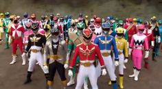 a large group of people dressed in colorful costumes and helmets, all standing side by side