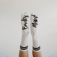 the legs of a person wearing white socks with black writing on them