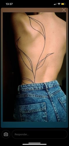 the back of a person's body with a tattoo on it, and an arrow