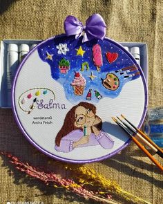 the embroidery kit is next to some knitting needles