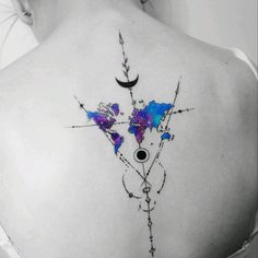 the back of a woman's shoulder with an artistic tattoo design on it,