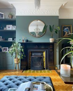 a living room filled with furniture and a fire place next to a mirror on the wall