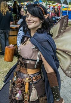 a woman dressed up as a fairy holding a coffee cup and wearing a brown dress