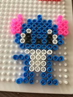 the legos are made to look like an animal with pink, blue and white circles on it