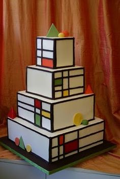 a multi - tiered cake is sitting on a table