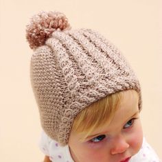 Free Intermediate Knit Hats Pattern For BabyA delicate hat with cable trim makes a darling gift for any tiny tot. Bernat Softee Baby is OEKO-TEX Standard 100 certified, so it's always safe to use. Select your color and let's get you on your way to completing a warm hat that looks priceless. Flat Knitting Patterns, Beany Hat, Baby Hat Knitting Patterns Free, Baby Hat Knitting Pattern, Hat Knitting Pattern, Baby Knitting Patterns Free, Hat Knitting, Baby Hats Knitting, Knit Hats