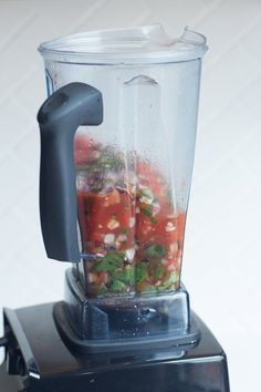 a blender filled with lots of food on top of a counter